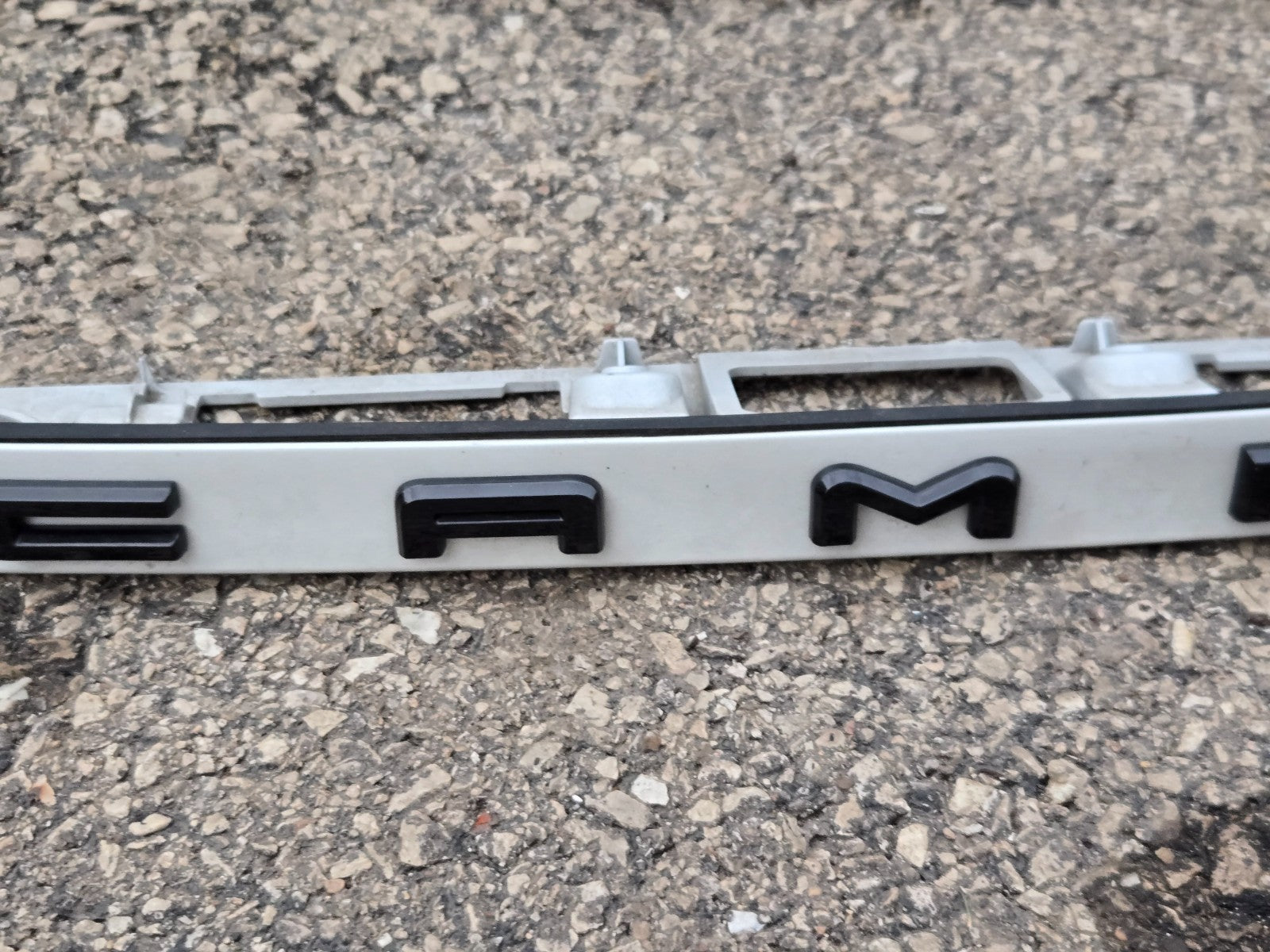 2021-24 TOYOTA CAMRY REAR TRUNK LID LICENSE PLATE MOLDING WHITE OEM 76811-06B70